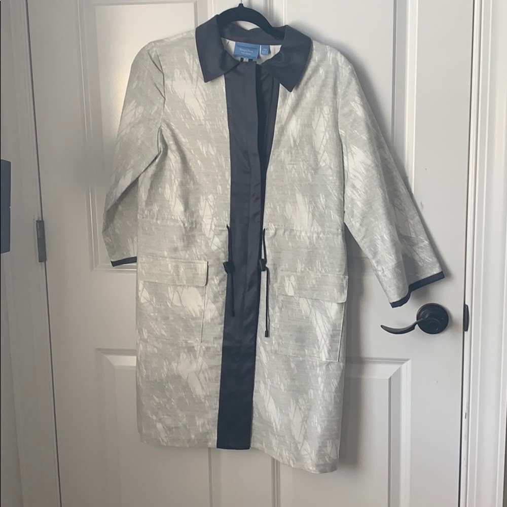A white and gray coat with a black  trim